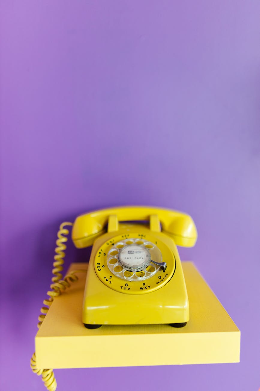 yellow telephone with cable